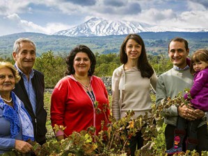 a family standing in front of a mountain