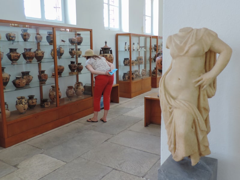 woman in red pants in a museum