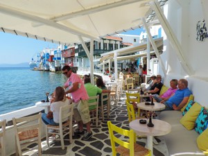 people having drinks along the water