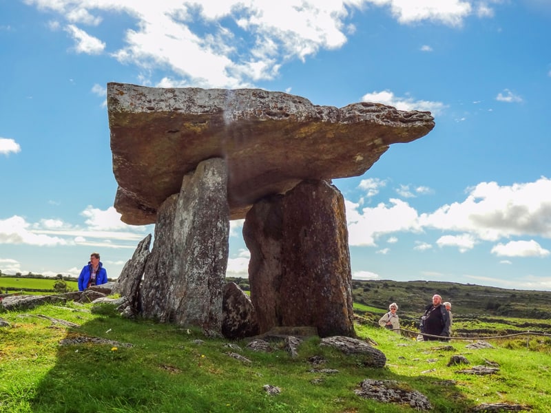 people looking at an ancient tomb on Ireland's West Coast