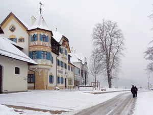 people on a road by colorful buildings