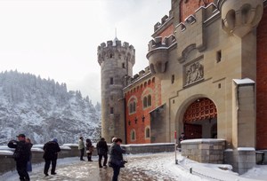 people by a red brick entrance
