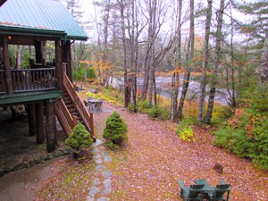 a view of the woods and river from a balcony at the Trout Point Lodge