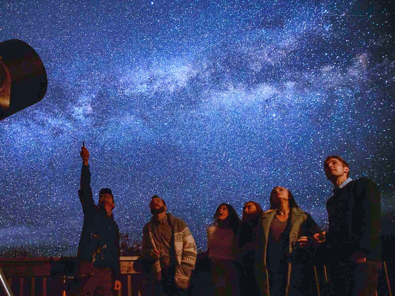 people viewing the stars with a guide