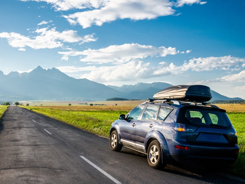 a car driving towards a mountain on a best road trip