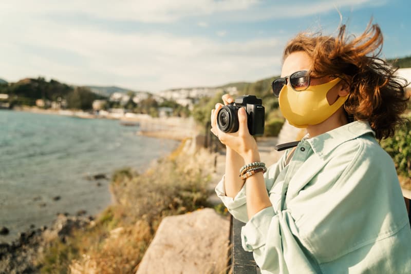 a woman taking a photo on a best road trip