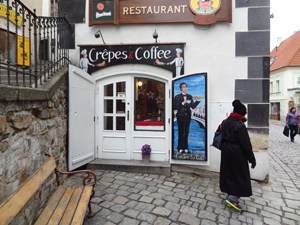 woman passing a coffee shop