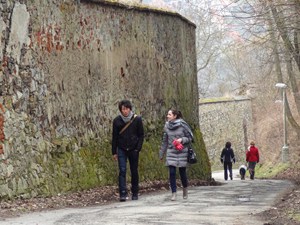 people walking along a wall seen on a day trip to Cesky Krumlov from Prague 