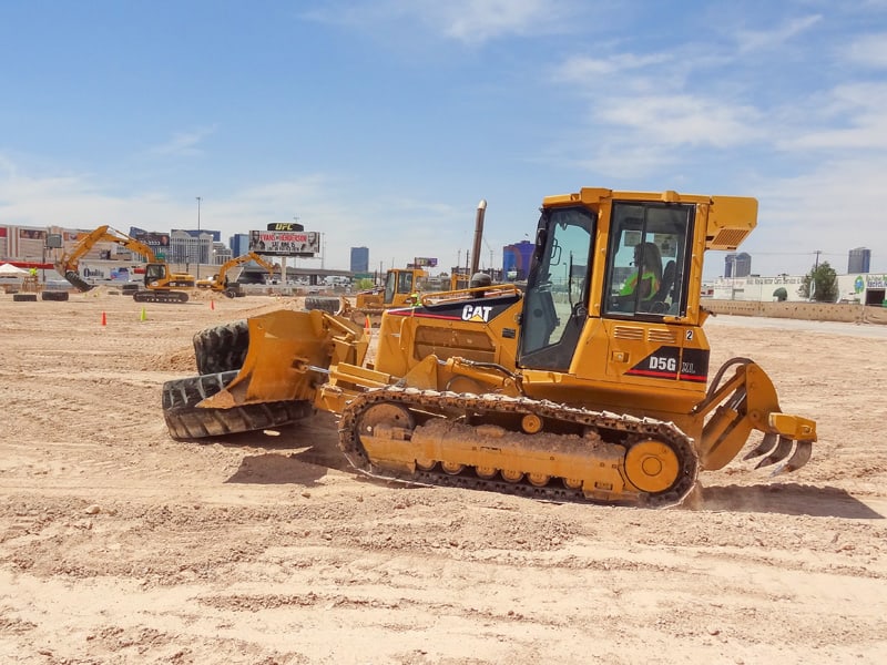 a woman driving a bulldozer, one of the popular Things to Do in Las Vegas Besides Gambling