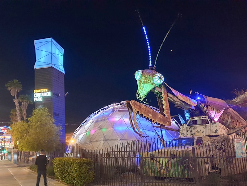 people looking at huge metallic sculptures in a park, one of the popular Things to Do in Las Vegas Besides Gambling