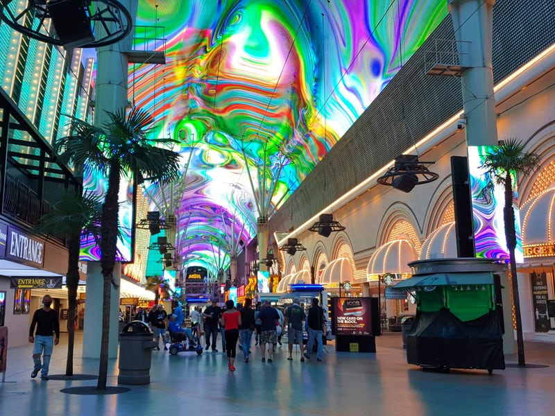 people walking through a large colorful mall, one of the popular Things to Do in Las Vegas Besides Gambling
