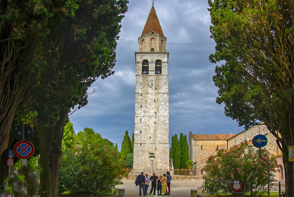 people by a bell tower in Friuli Venezia Giulia