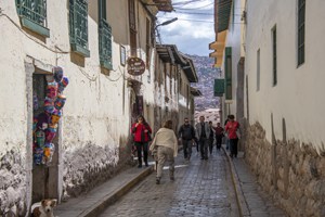 people walking down an ancient street seen in Cusco and the Sacred Valley in Peru