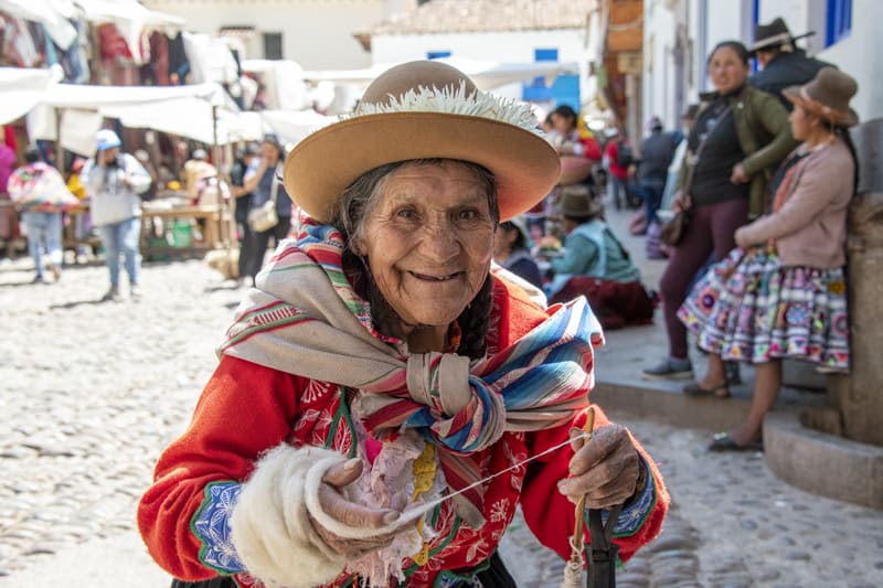 a woman in red seen in seen in Cusco and the Sacred Valley in Peru