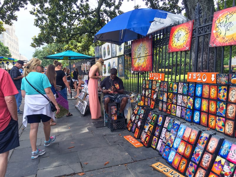 Viewing work of sidewalk artists, one of the things to do in New Orleans on a budget