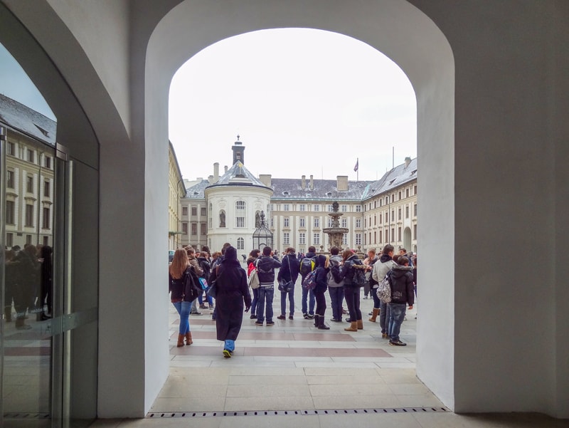 People in the courtyard of a castle, one of the places to see on a 2 day itinerary in Prague