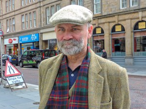 a bearded man with a cap seen on a Highlands of Scotland road trip