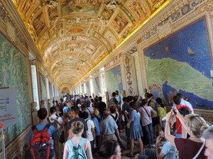 people in a museum under a gold ceiling