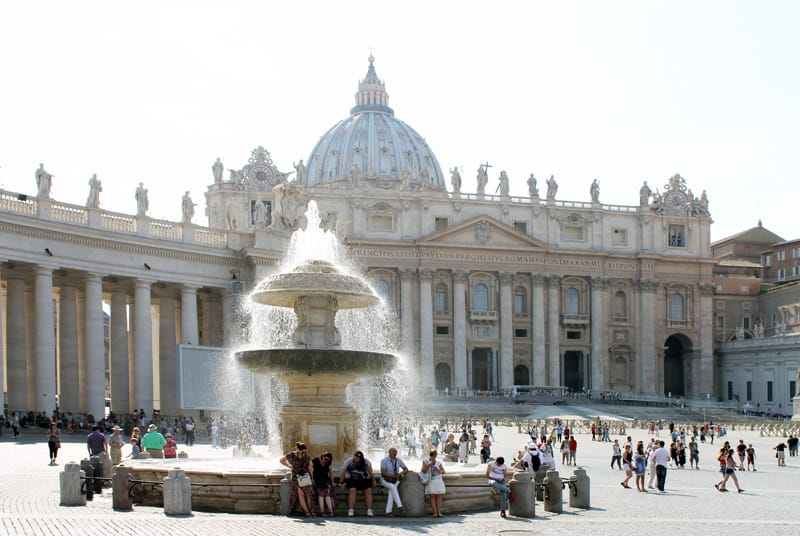 a fountain in front of St . Peter's Basilica seen on walks in Rome