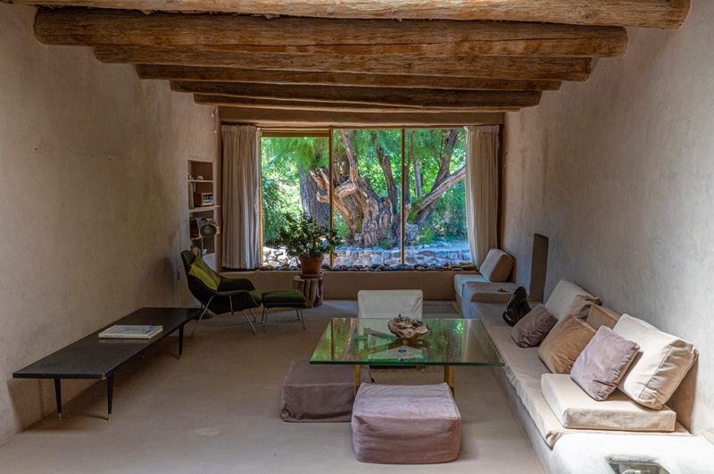 a room with a ceiling of large wood poles