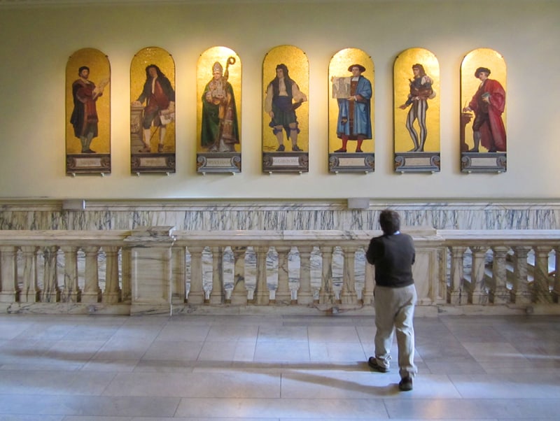 man looking at statues in one of the museums of South kensington