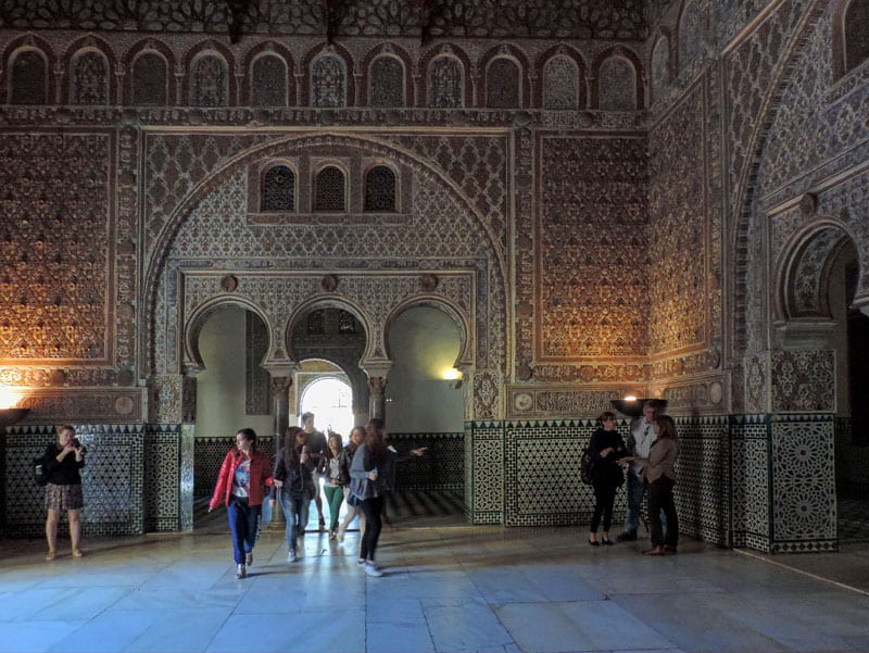 people touring a magnificent Moorish palace,  one of the things to do in Seville