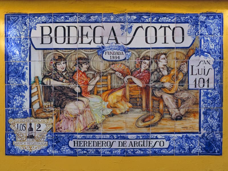a colorful tile sign for a bodega