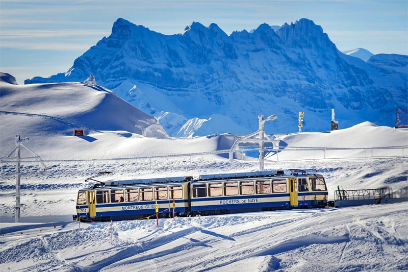 a cog railway train in the snow