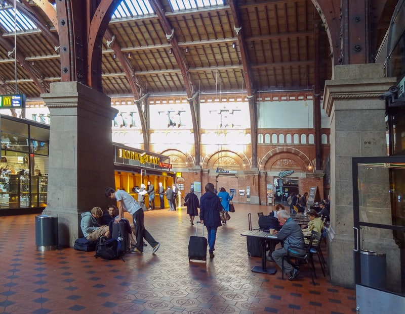 people walking through a train station seen during one day in Copenhagen