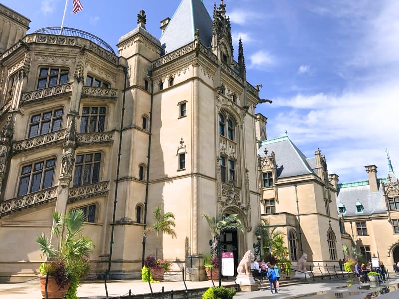 people in front of the ornate Biltmore estate