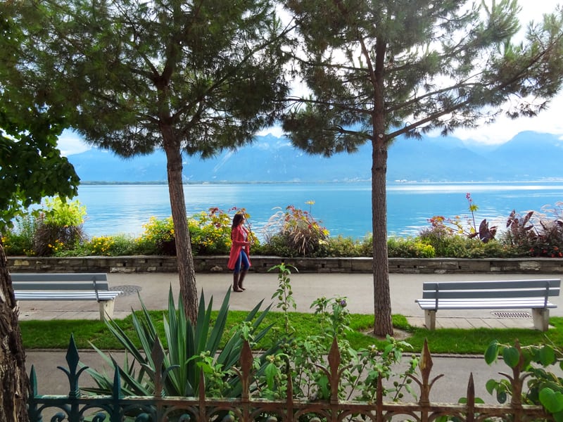 a woman walking along a lake in Montreux Switzerland