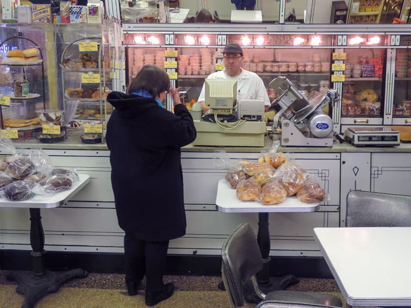 a woman buying food in one of the delis in New York City