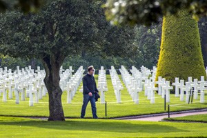 man in a Normandy cemetery, one of the historic places in France
