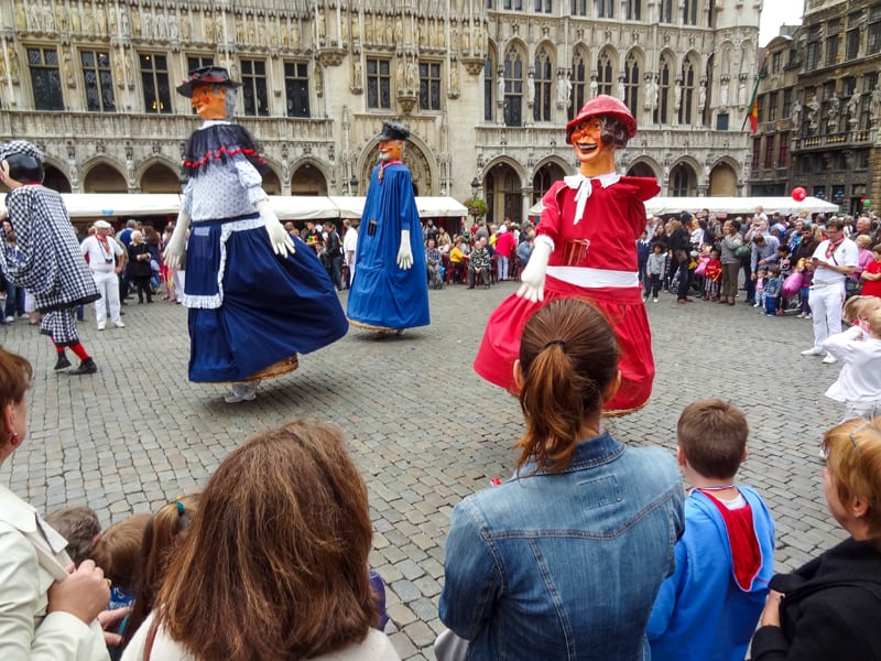 a festival with tall puppets in  one of the places to visit in Belgium