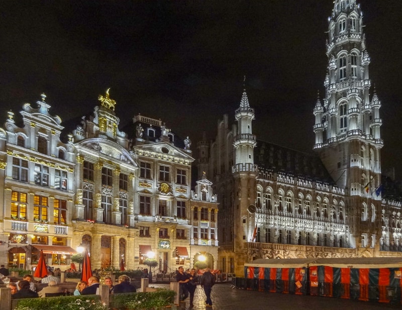 an ornate square at night in one of the places to visit in Belgium