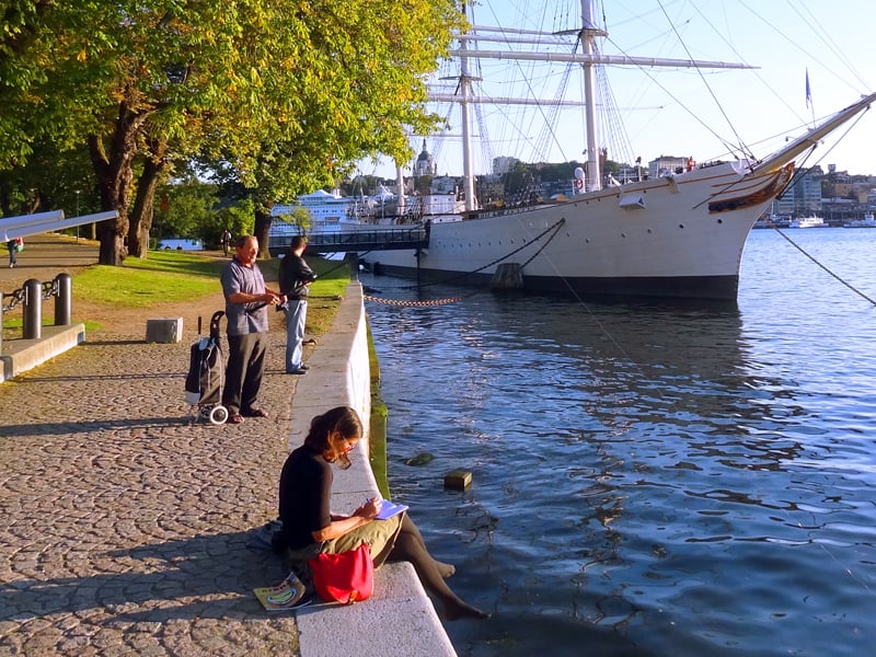 people by an old sailing ship