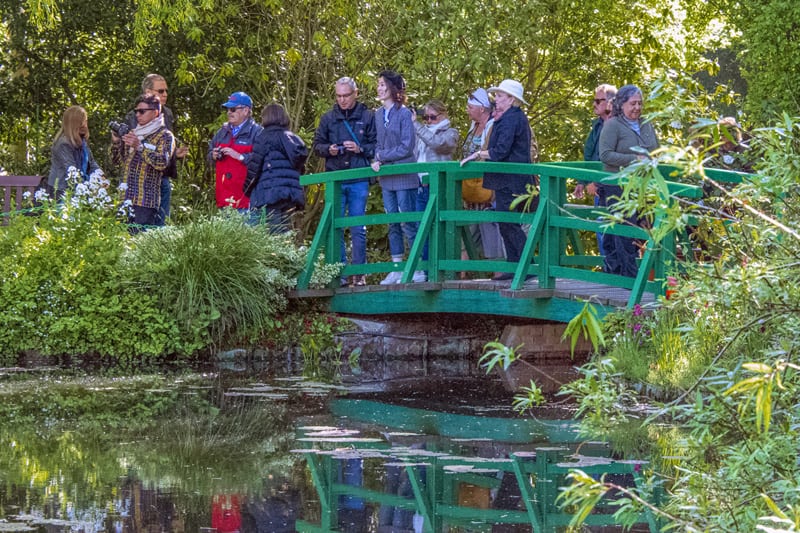 people on a bridge seen in Monet House and Gardens