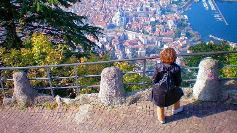 A woman in Brunate Como looking down on the lake