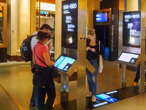 people at a kiosk in a museum