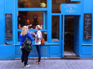 women outside a shop painted blue