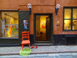 a red chair in front of an art gallery seen during 3 days in Stockholm