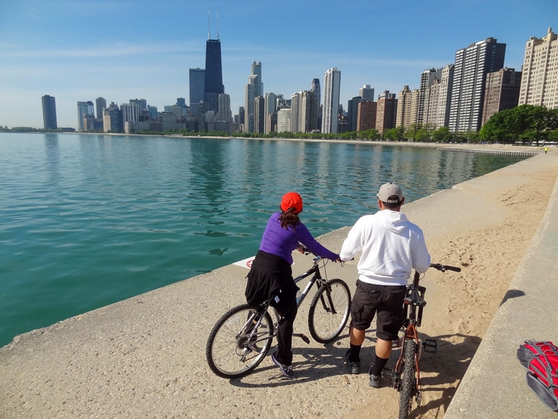 bicyclist along a lake in a city, one of the things to do in Chicago