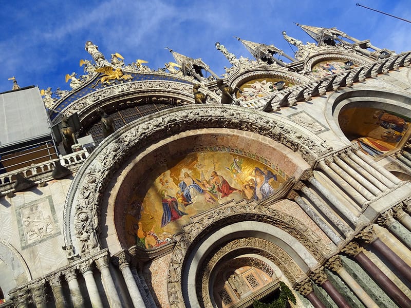 a colorful mosaic on an old building, one of the best places to visit in Venice