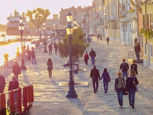 people walking along a broad walkway in one of the best places to visit in Venice