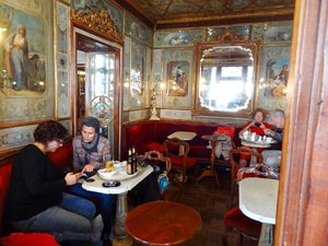 people in an ornate cafe room in one of the best places to visit in Venice