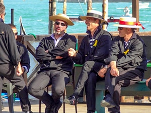 men with hats talking in one of the best places to visit in Venice