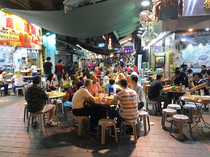 people at crowded tables in the street in Hong Kong - 24 hours in Hong Kong