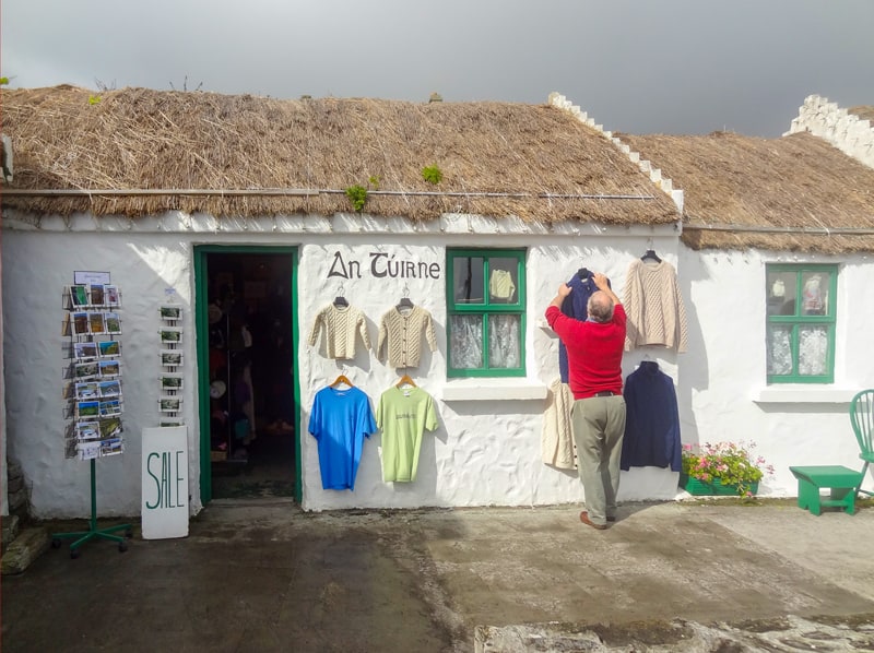 a man outside his shop getting ready to open - 24 hours on Ireland's Aran Islands