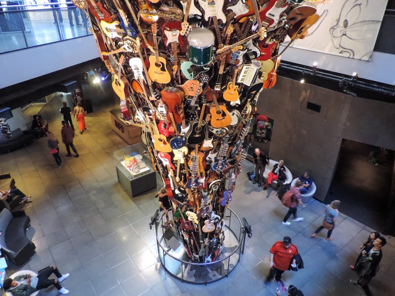 people looking at a museum exhibit of musical instruments - one of the things to do in Seattle