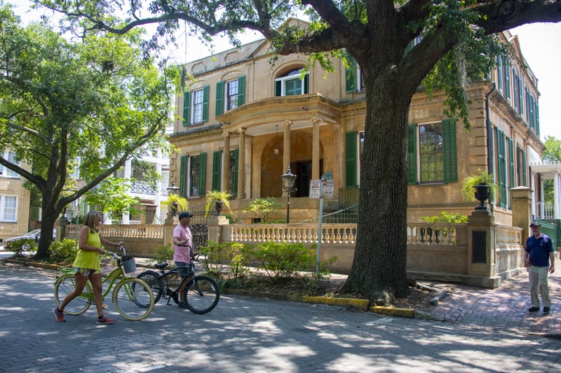 a couple bicycling on a street, one of the things to do in Savannah